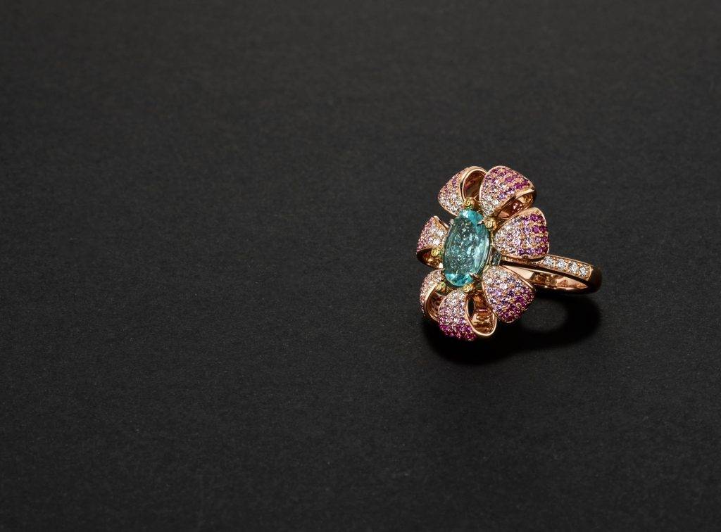 Beautiful gemstone floral ring featuring pink and white stones set in gold.