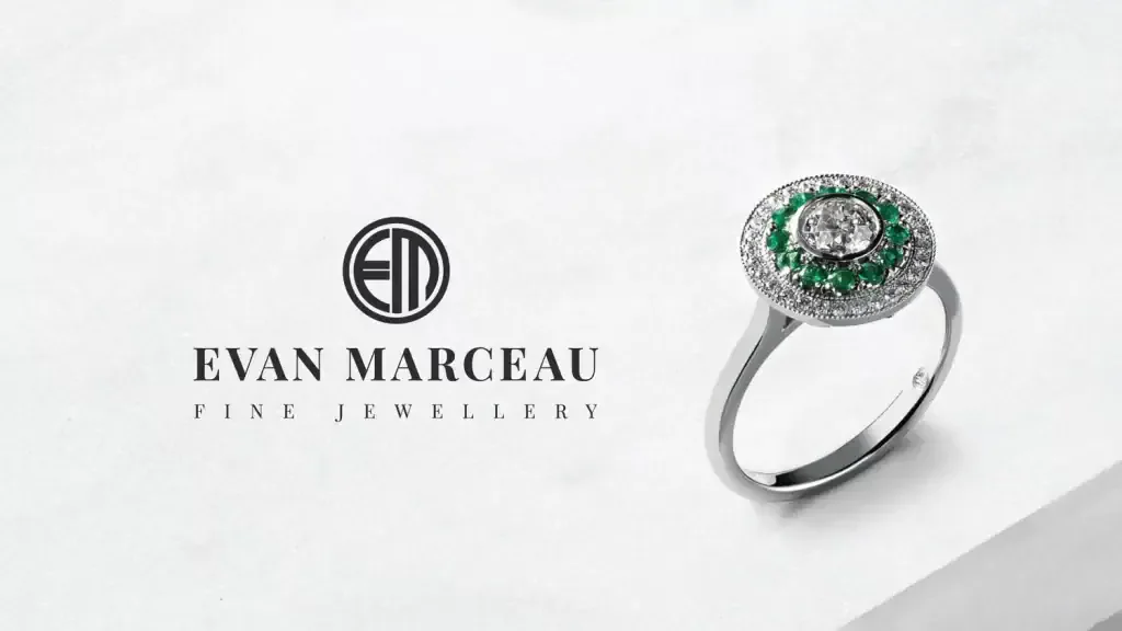 Luxurious engagement or statement ring with sparkling diamonds and vibrant green emeralds.