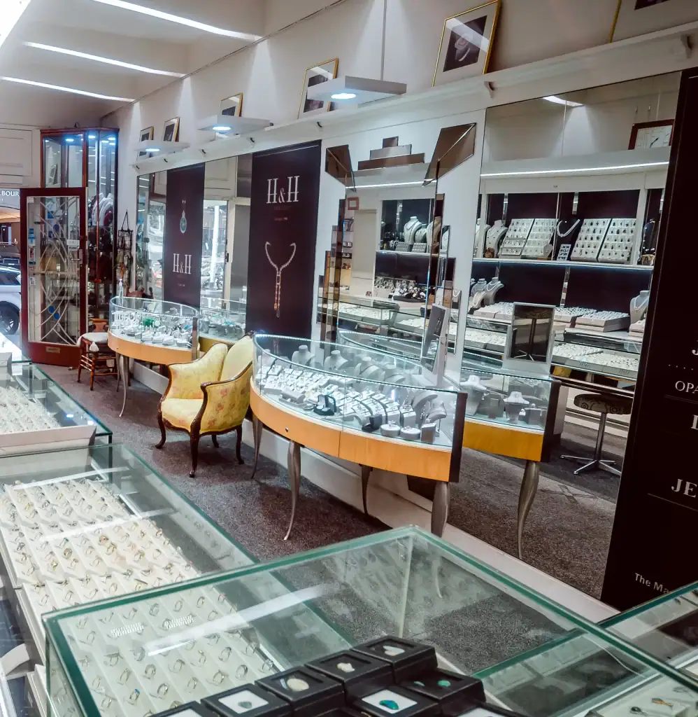 Bright jewellery shop showcasing rings, necklaces, and fine accessories in glass display cases.