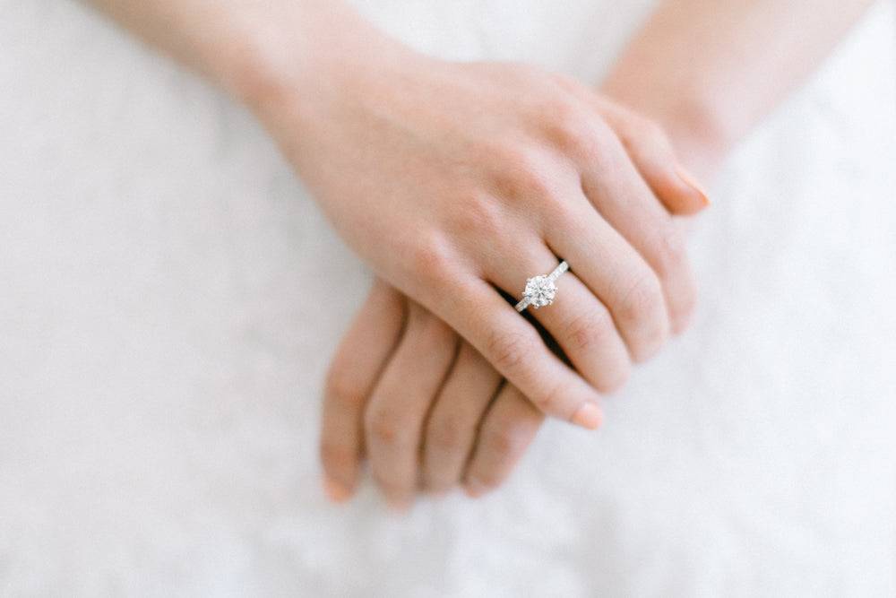 Close-up of a stunning engagement ring on a woman's hand showcasing fine jewellery craftsmanship in Sydney.