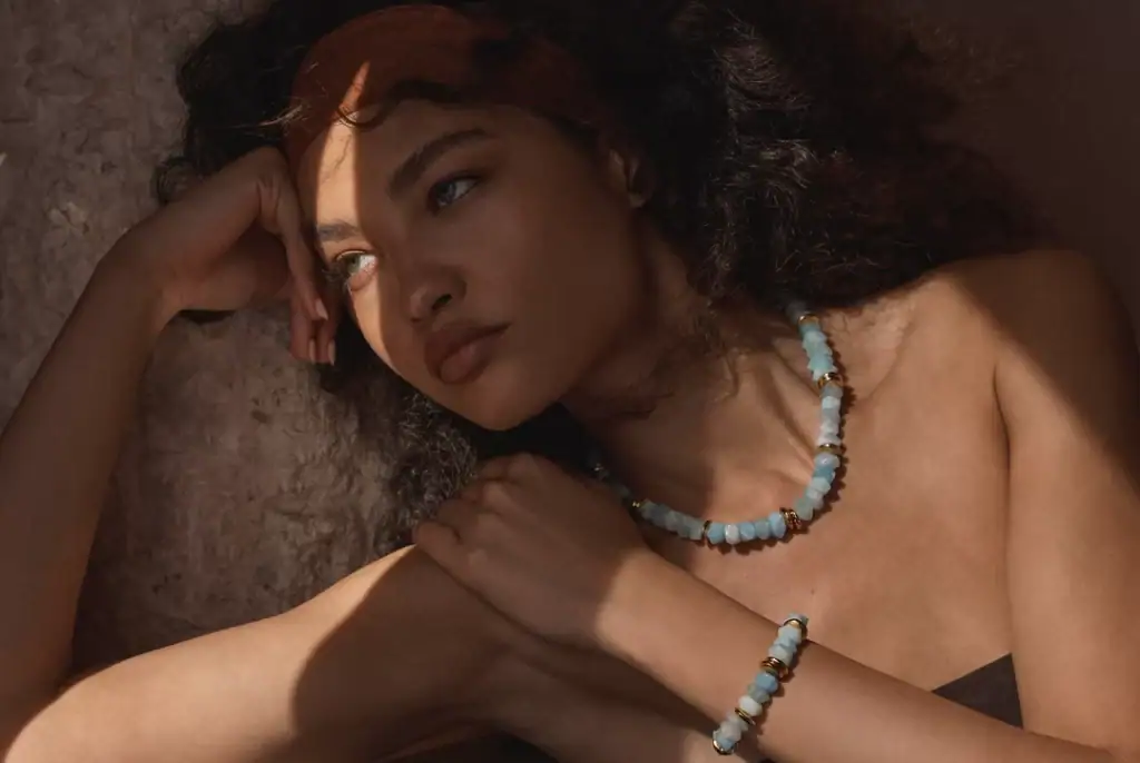 Beautiful aqua beaded necklace and bracelet with gold accents for women.