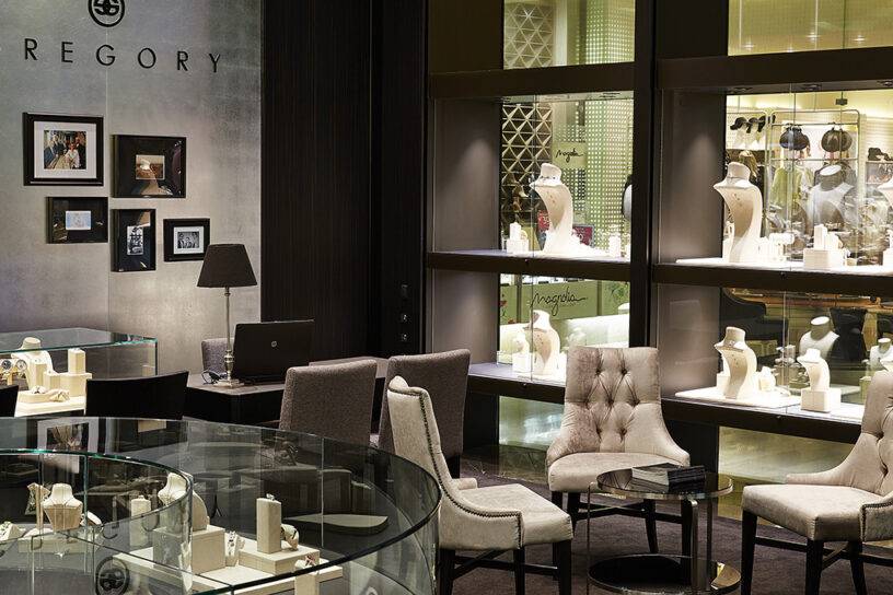 Elegant jewellery display in a luxurious jeweller's store showcasing engagement and wedding rings.