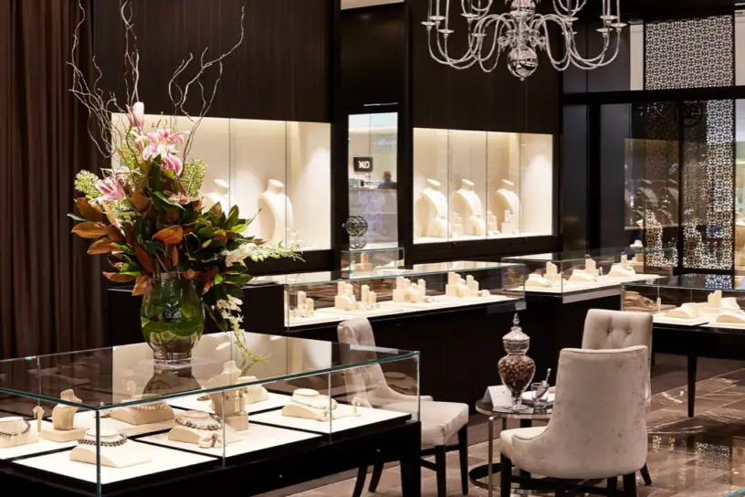 Luxurious jewellery showcase with necklaces, rings, and bracelets, featuring stylish display cases and modern decor.
