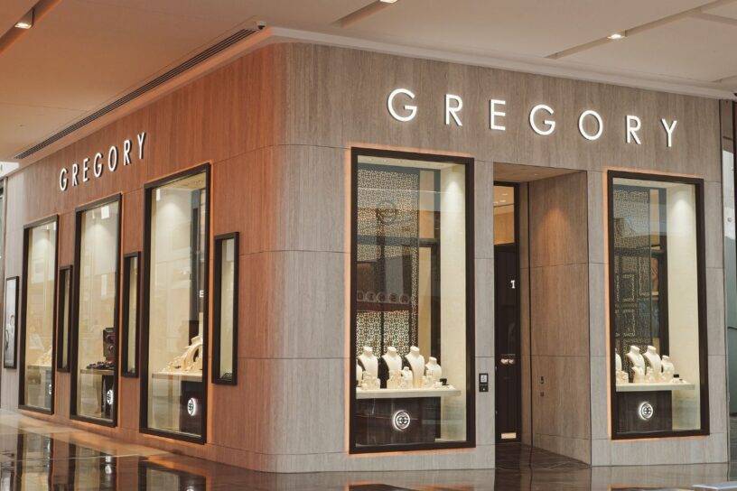 Elegant jewellery store facade with display windows showcasing luxury pieces.
