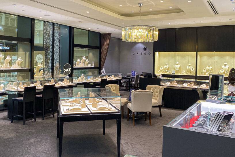 Luxurious jewellery store displays fine rings, necklaces, and accessories in a sophisticated setting.