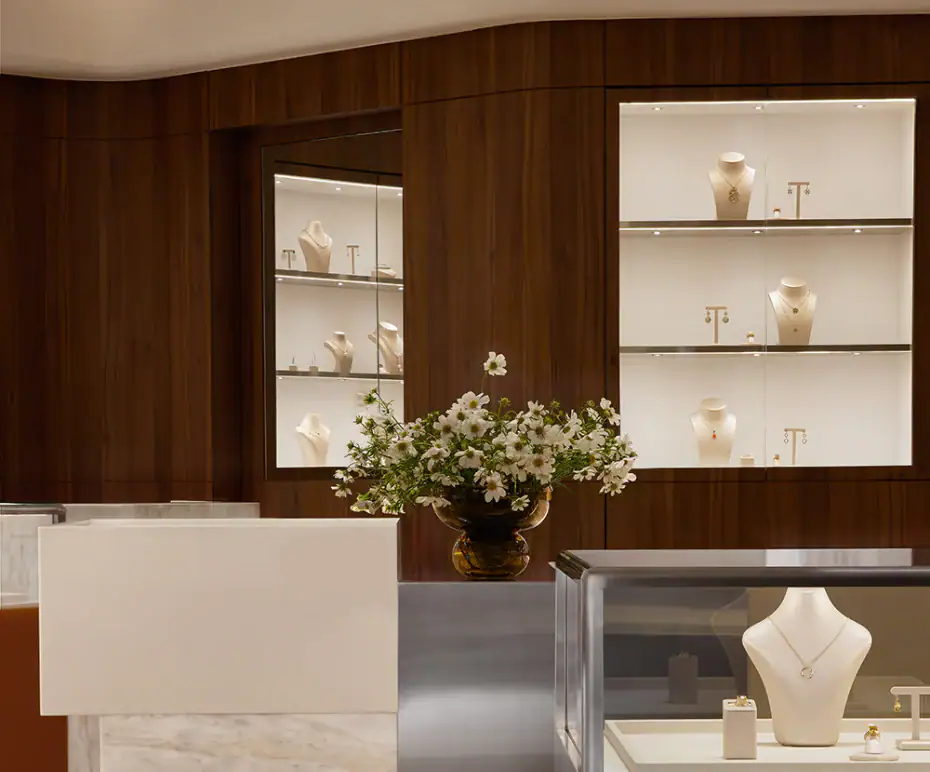 Luxurious jewellery showcase with necklaces and rings in a modern boutique store.