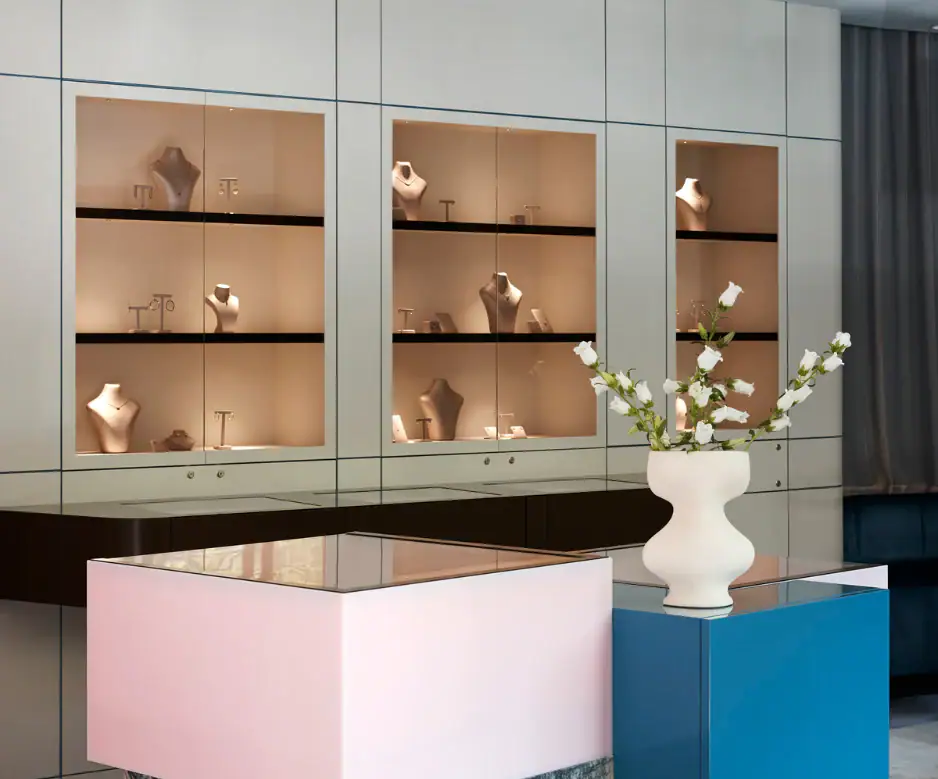 Elegant jewellery display cabinet with necklace busts and key accessories.