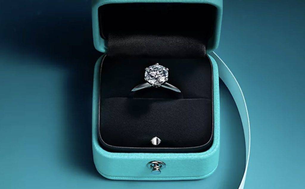 Stunning solitaire diamond ring presented in a vibrant blue jewellery box.